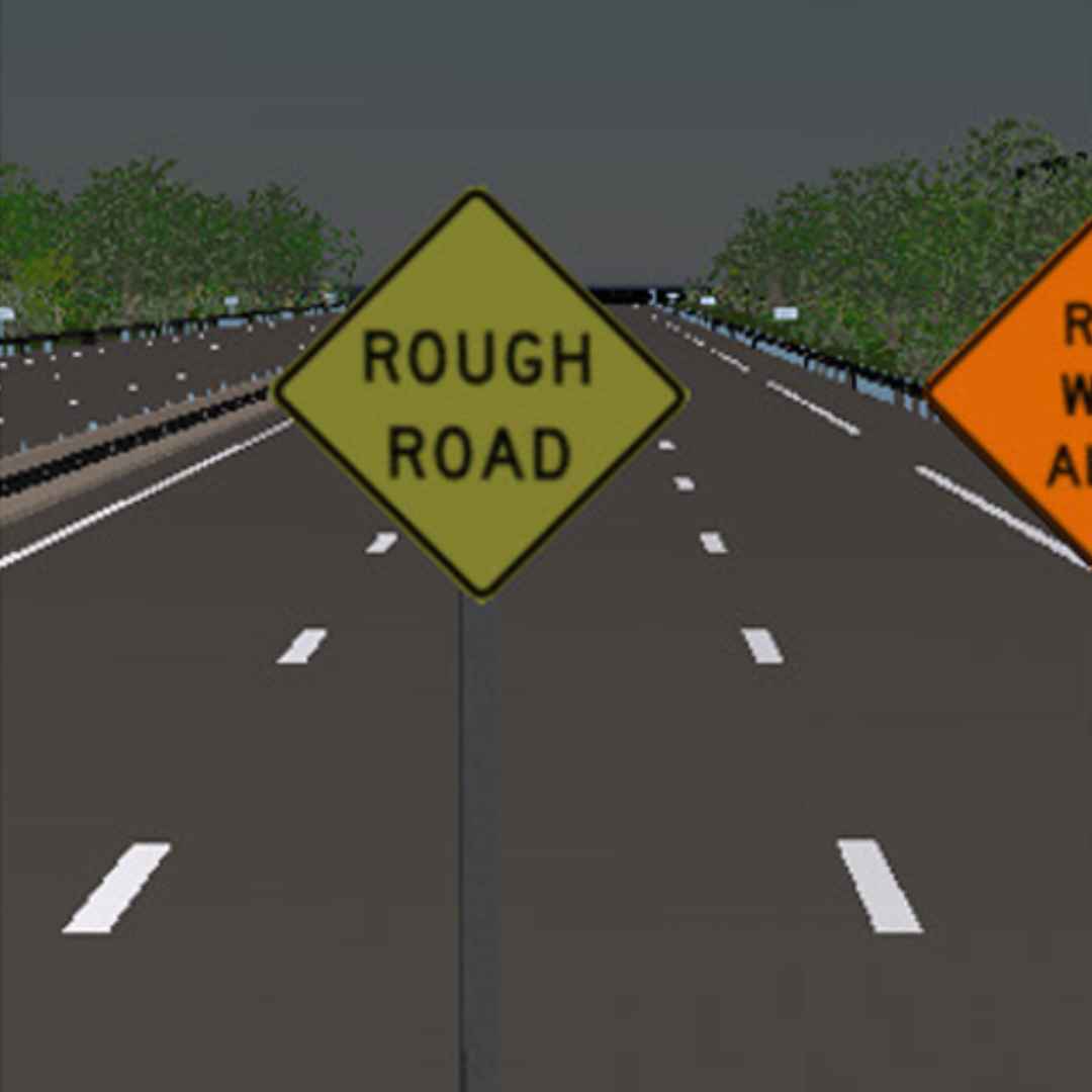 Road sign indicating 'Rough Road' on a highway with trees on either side.